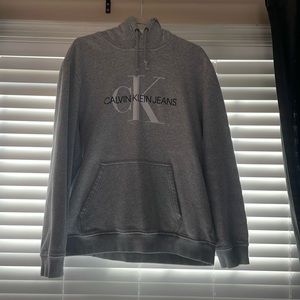 This is a XL sized sweatshirt. The color is grey. The Brand is Calvin Klein.